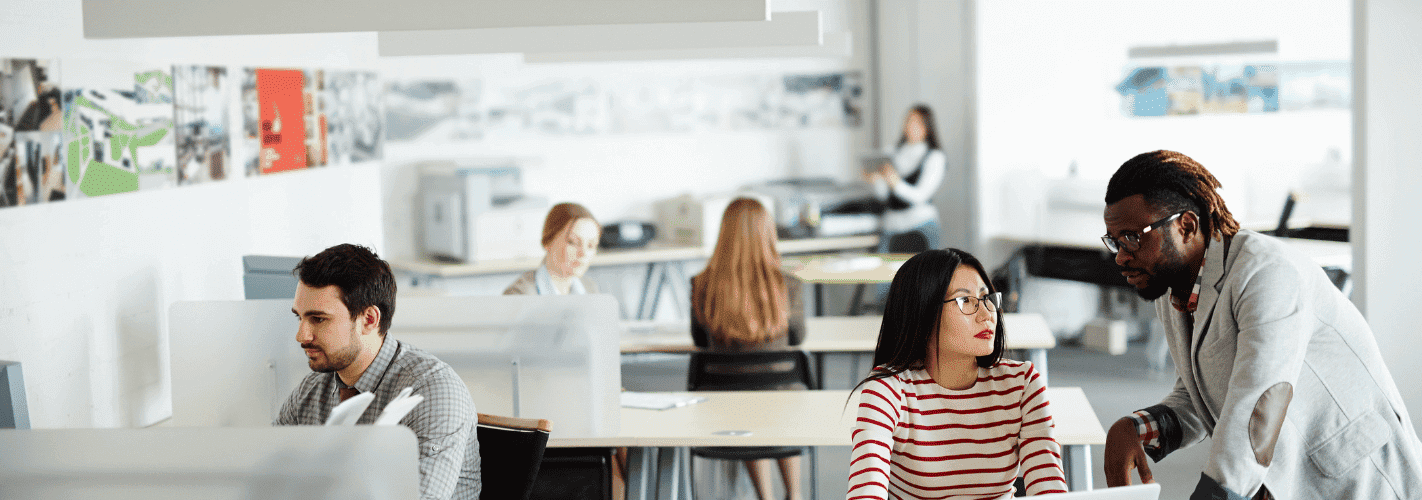 workers sitting in an open office with furniture